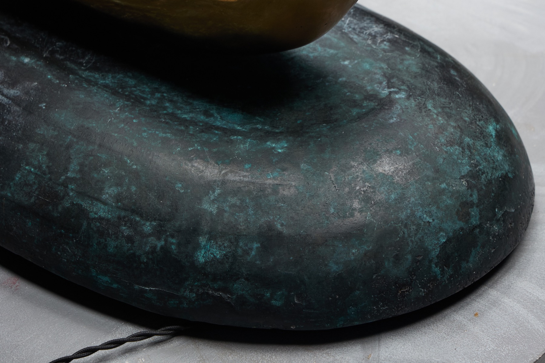 Sculptural bronze light object depicting an angler figure