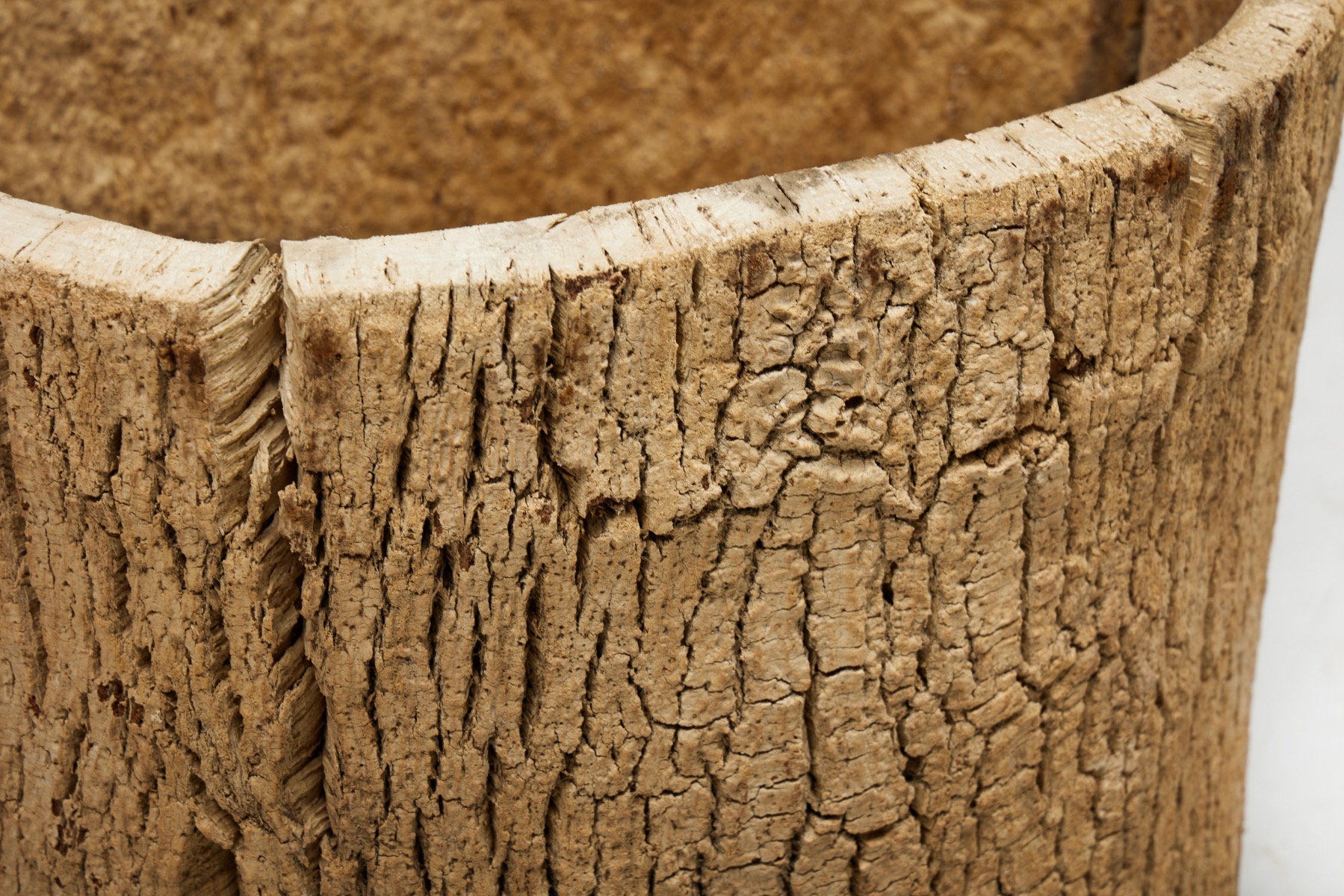 Early handmade tree trunk basket in wood