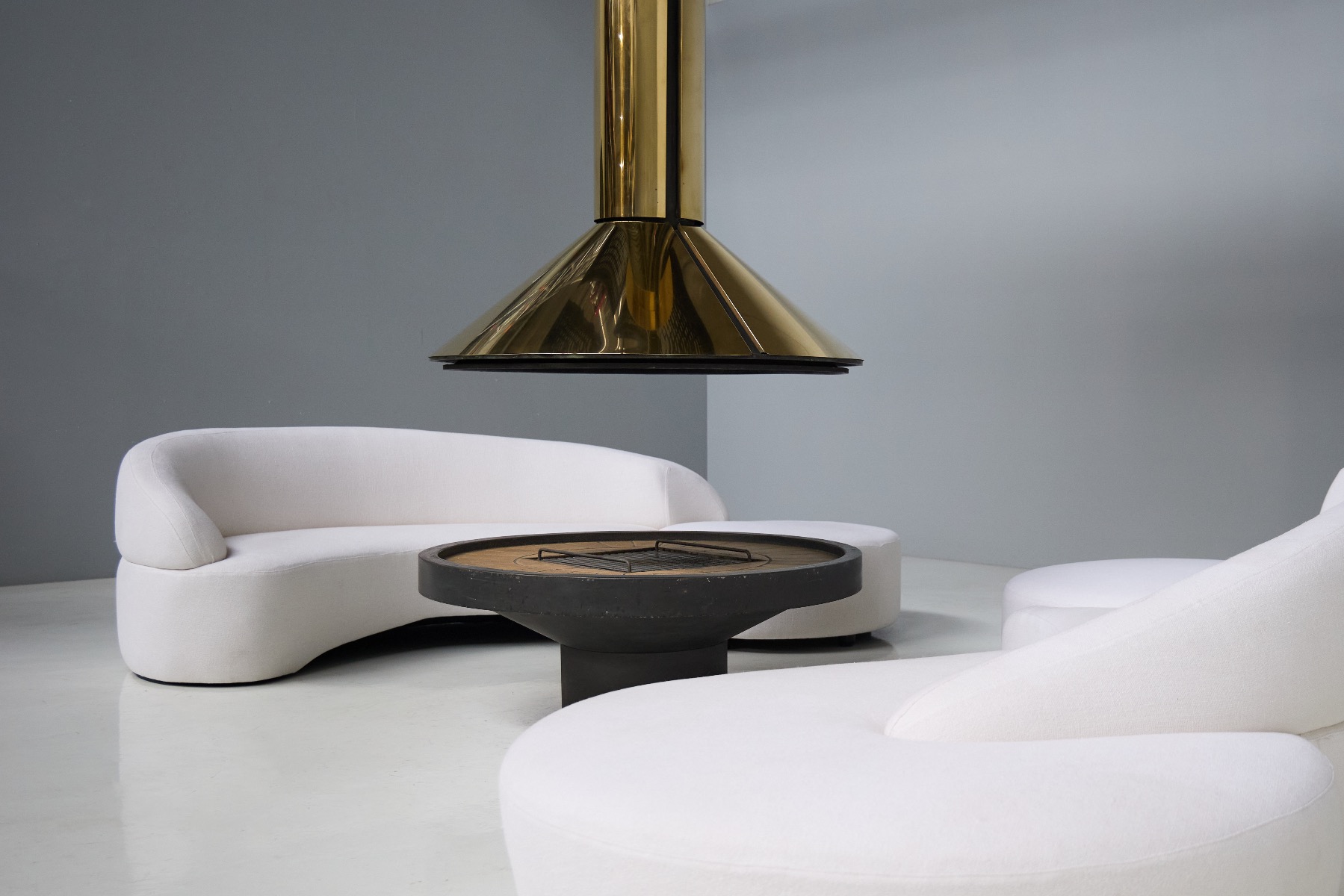 Gallery level brass fireplace with sculptural design