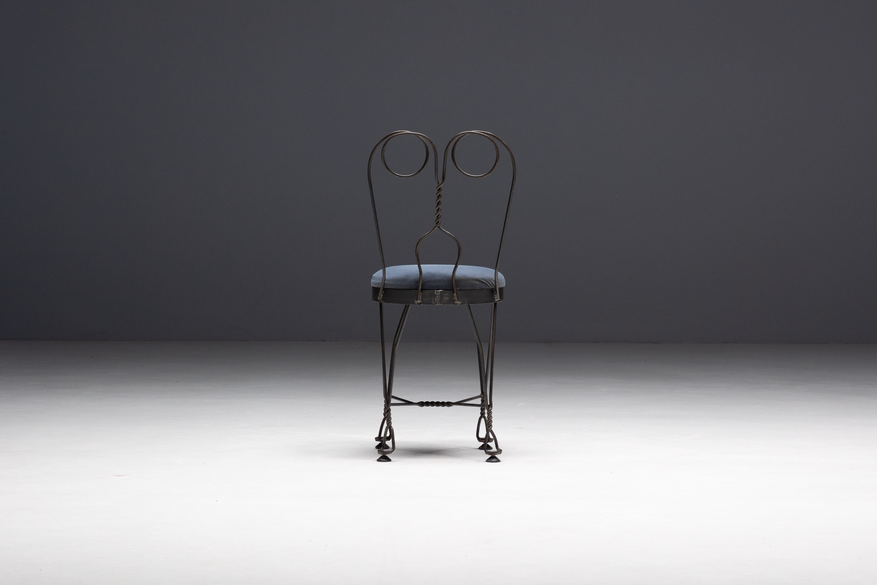Gallery level wrought iron butterfly chair with sculptural presence