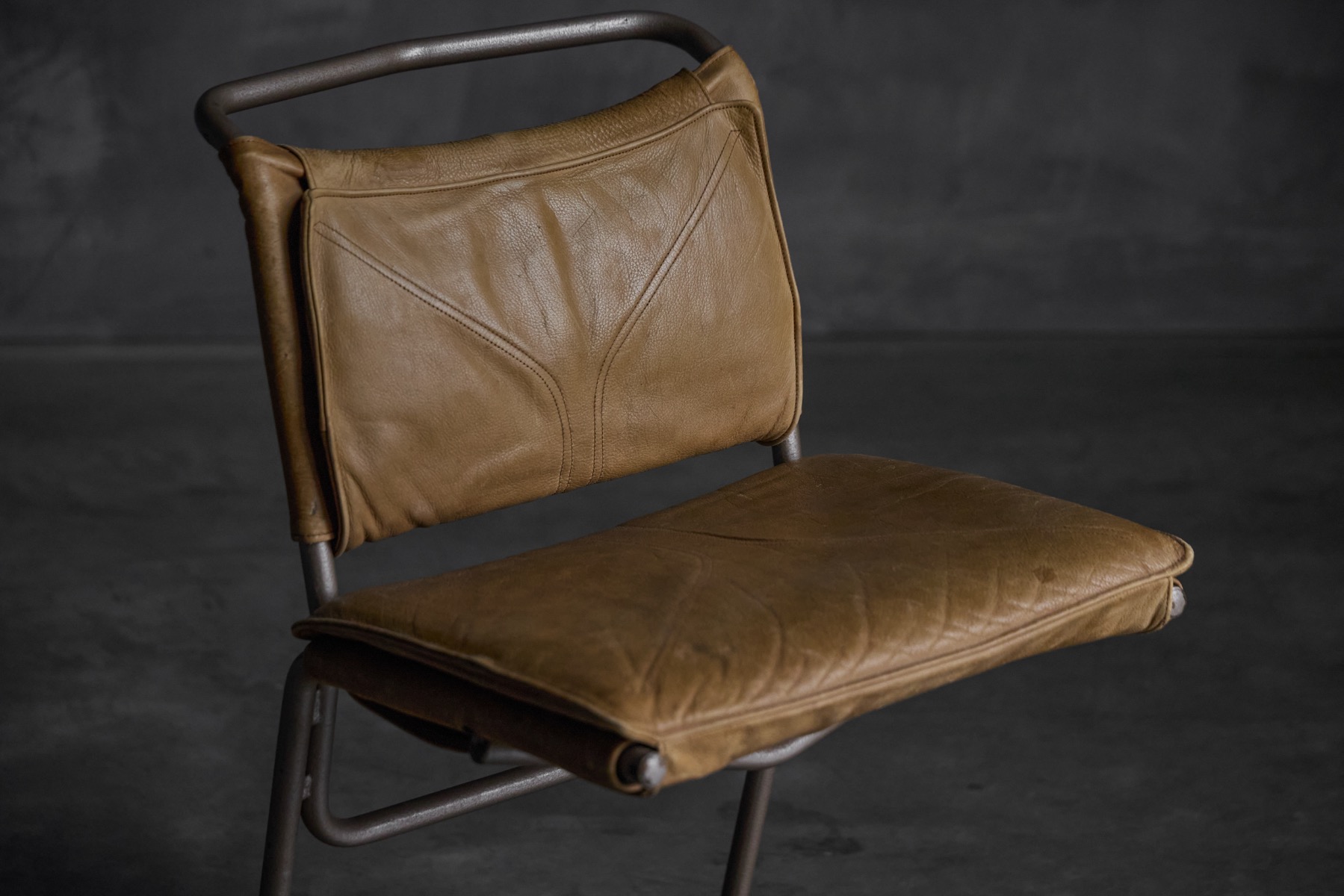 Steel base dining chairs with leather seating surfaces
