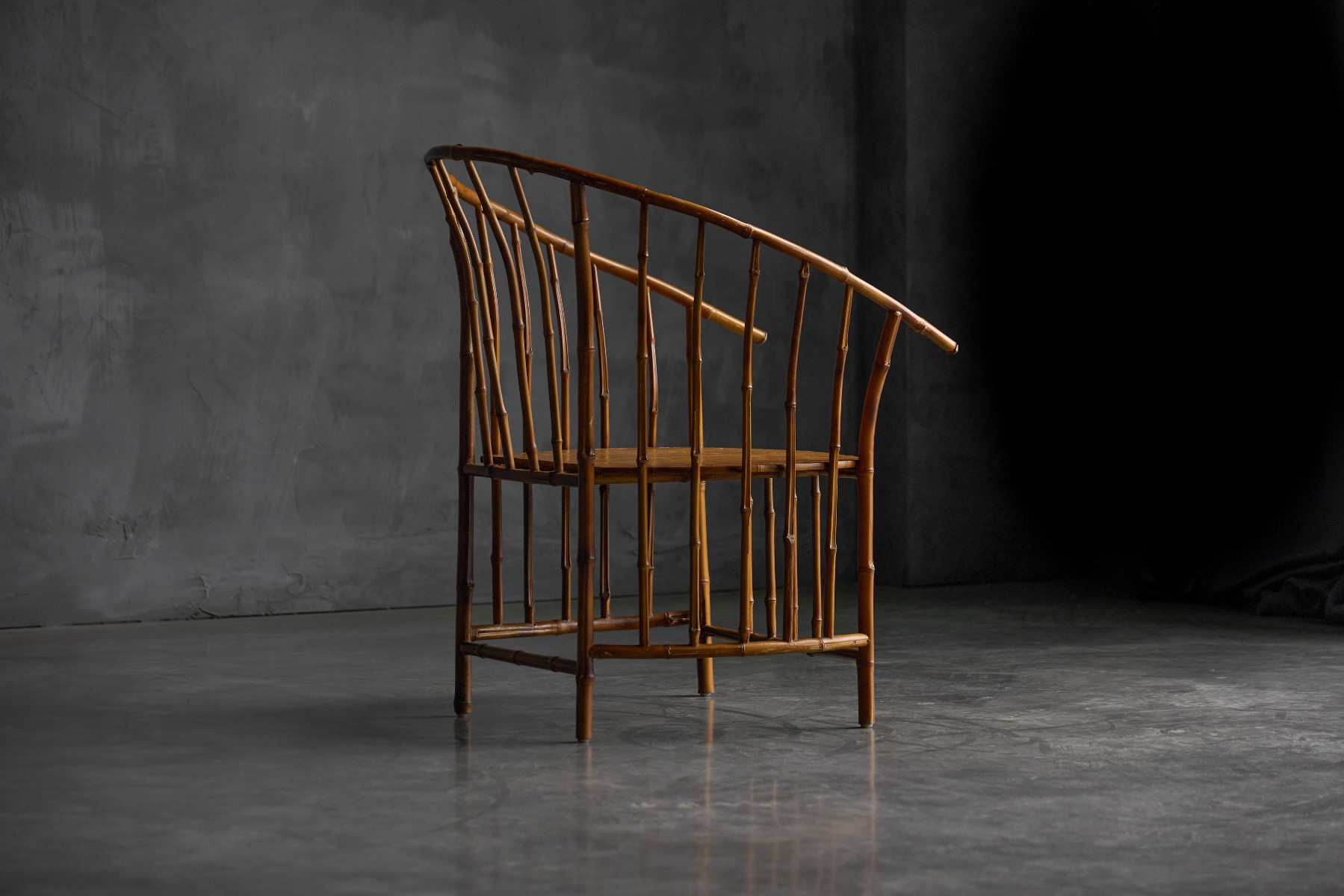 Low bamboo armchair with understated wabi sabi design