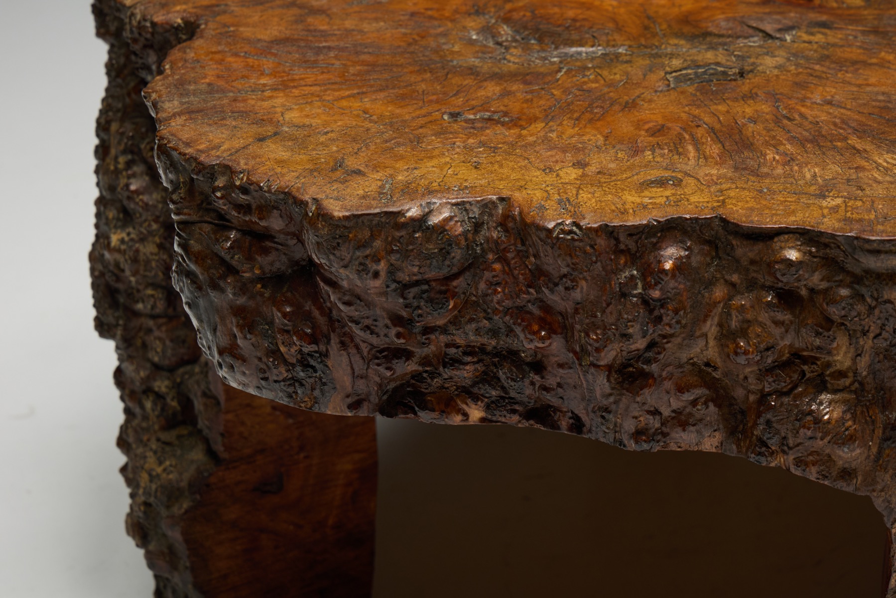 Solid burl wood coffee table with expressive grain and organic contours