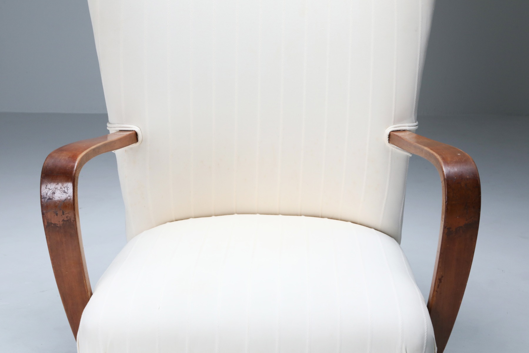 Iconic white wingback chair with ottoman from the 1950s