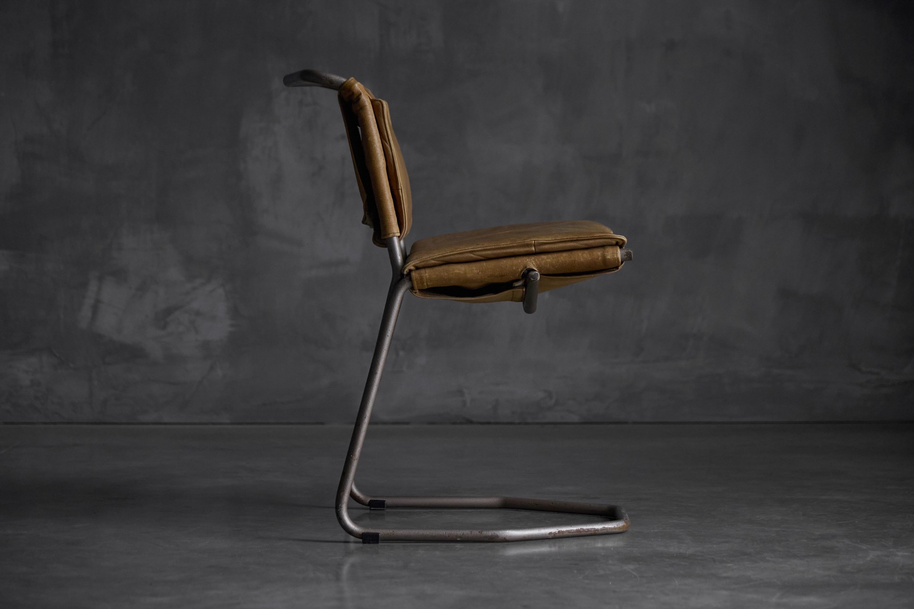 Designer dining chairs in leather and steel by Rombouts