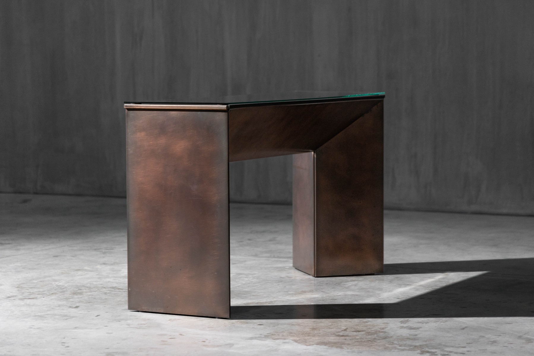 Textured patinated bronze console table with rich surface