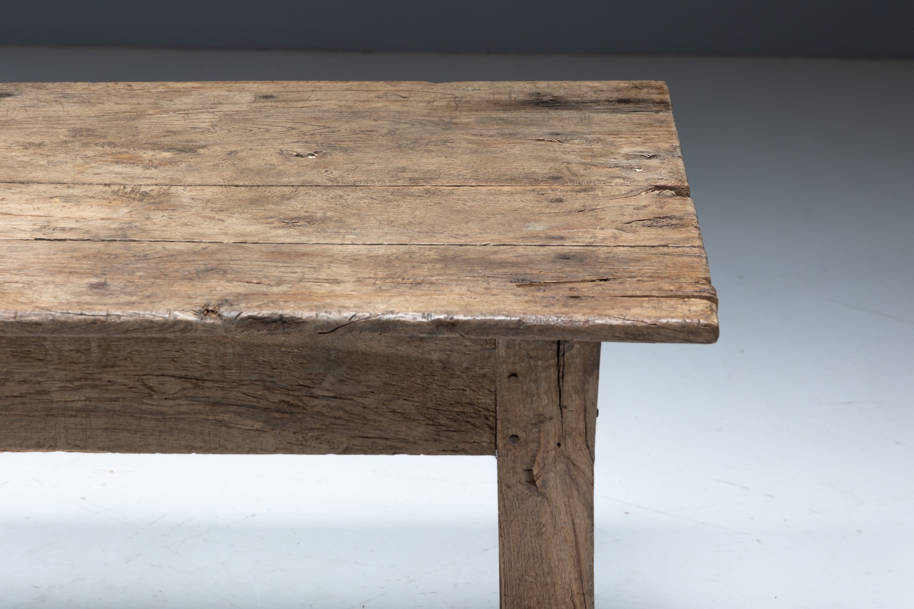 Aged wood farmhouse dining table with natural imperfections