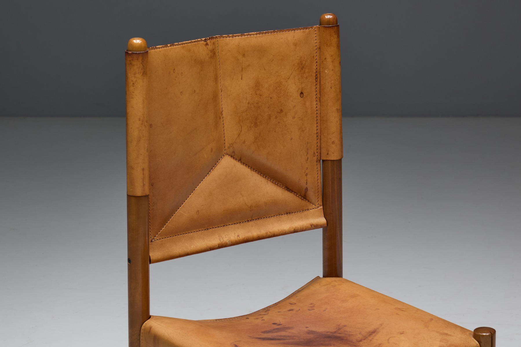 Warm toned leather dining chairs with vintage character