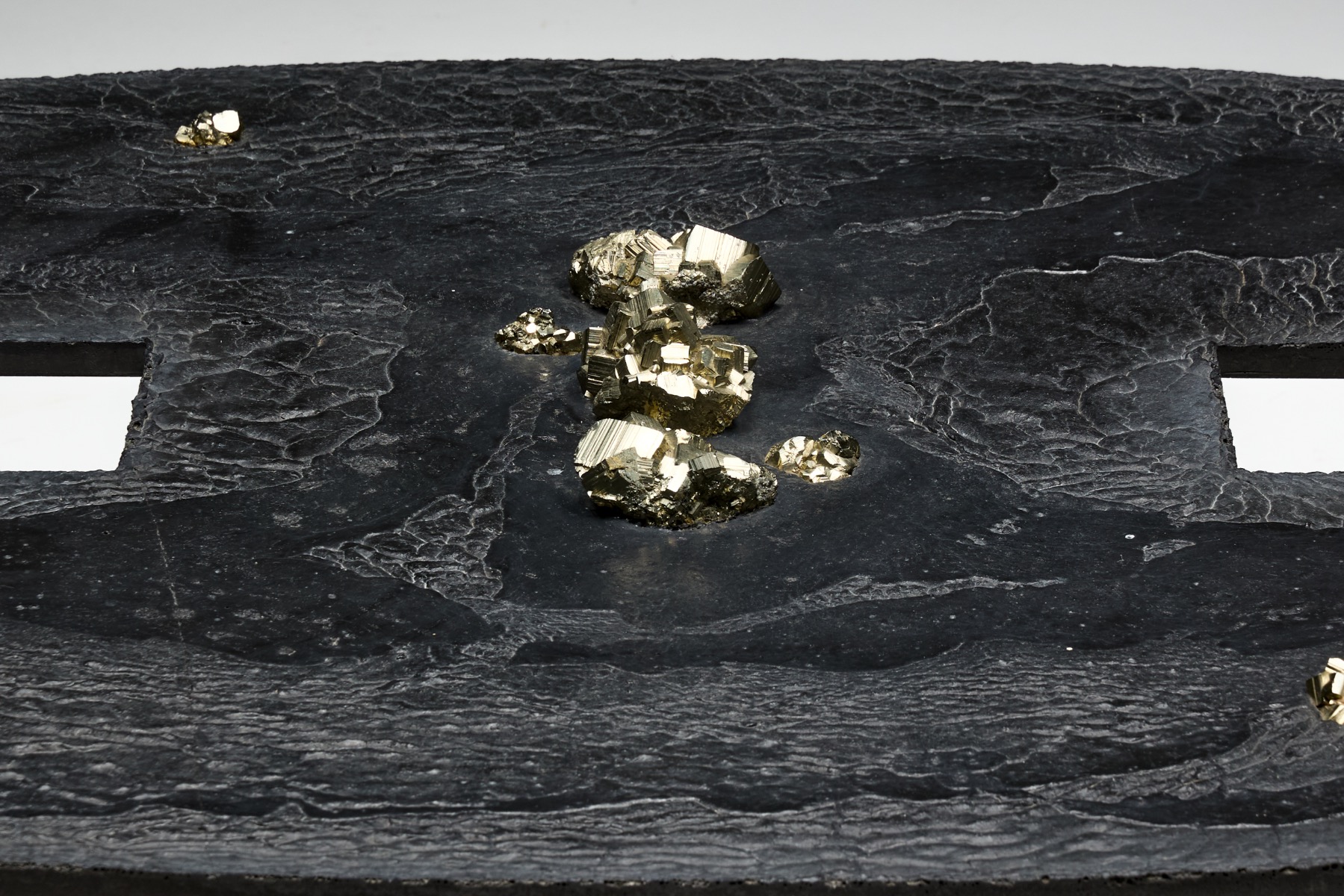 Brutalist iron coffee table expressing raw mineral materiality