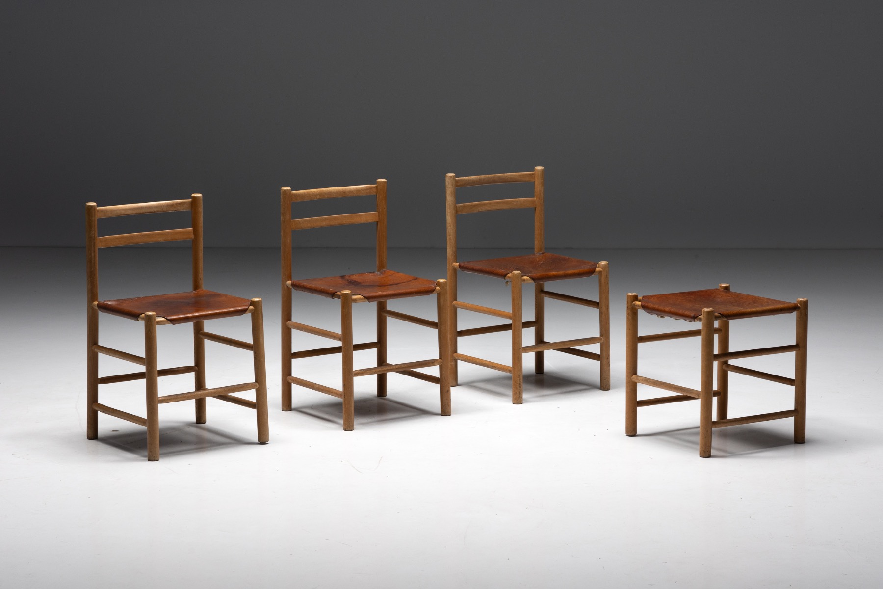 Refined French dining chairs in leather and wood from the 1950s