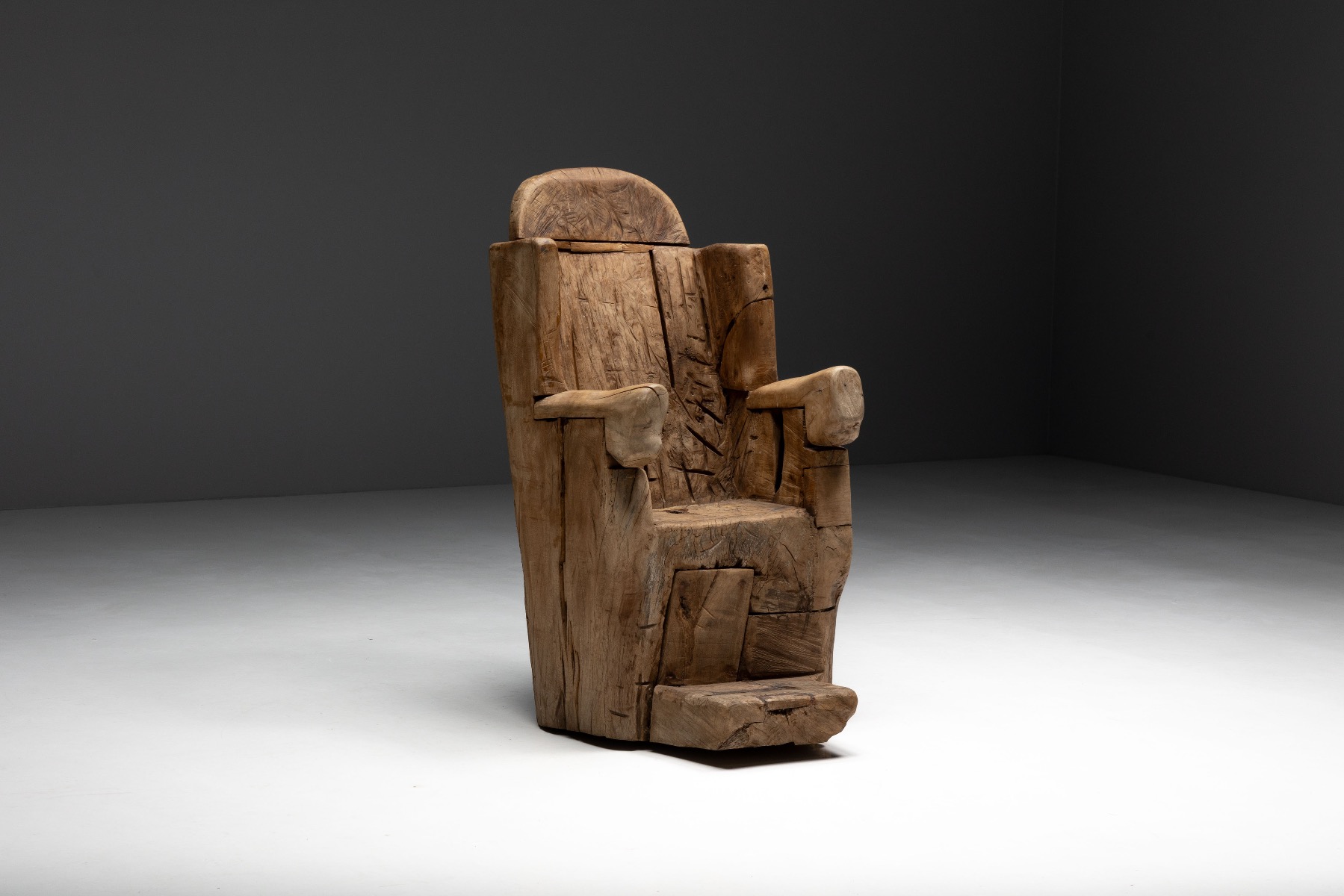 Tribal inspired monoxylite throne chair with sculptural weight