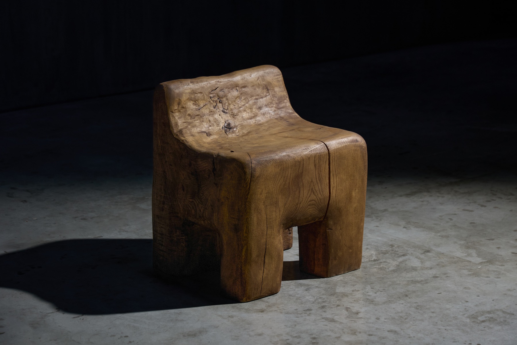 Design driven brutalist chair carved from solid wood