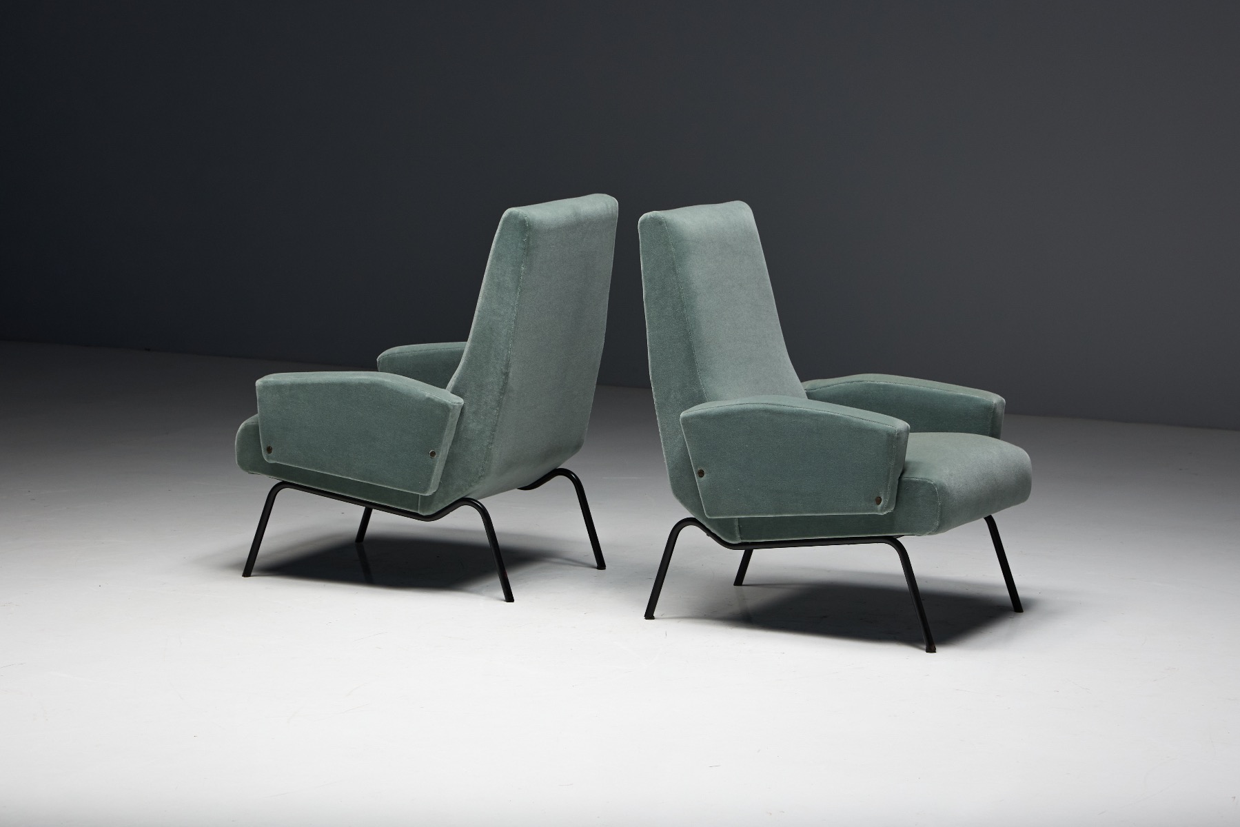 Refined Italian lounge chairs with curved silhouette