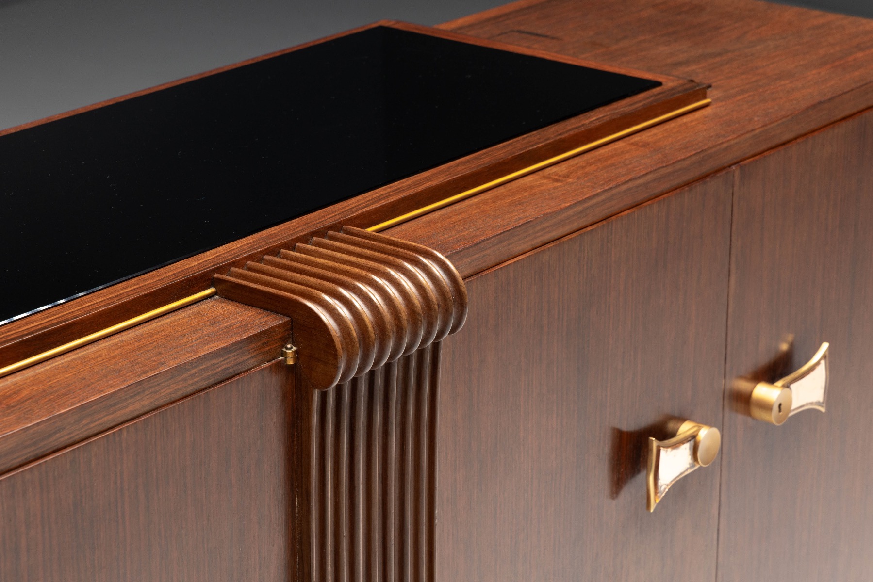 Art Deco sideboard combining walnut and brass materials