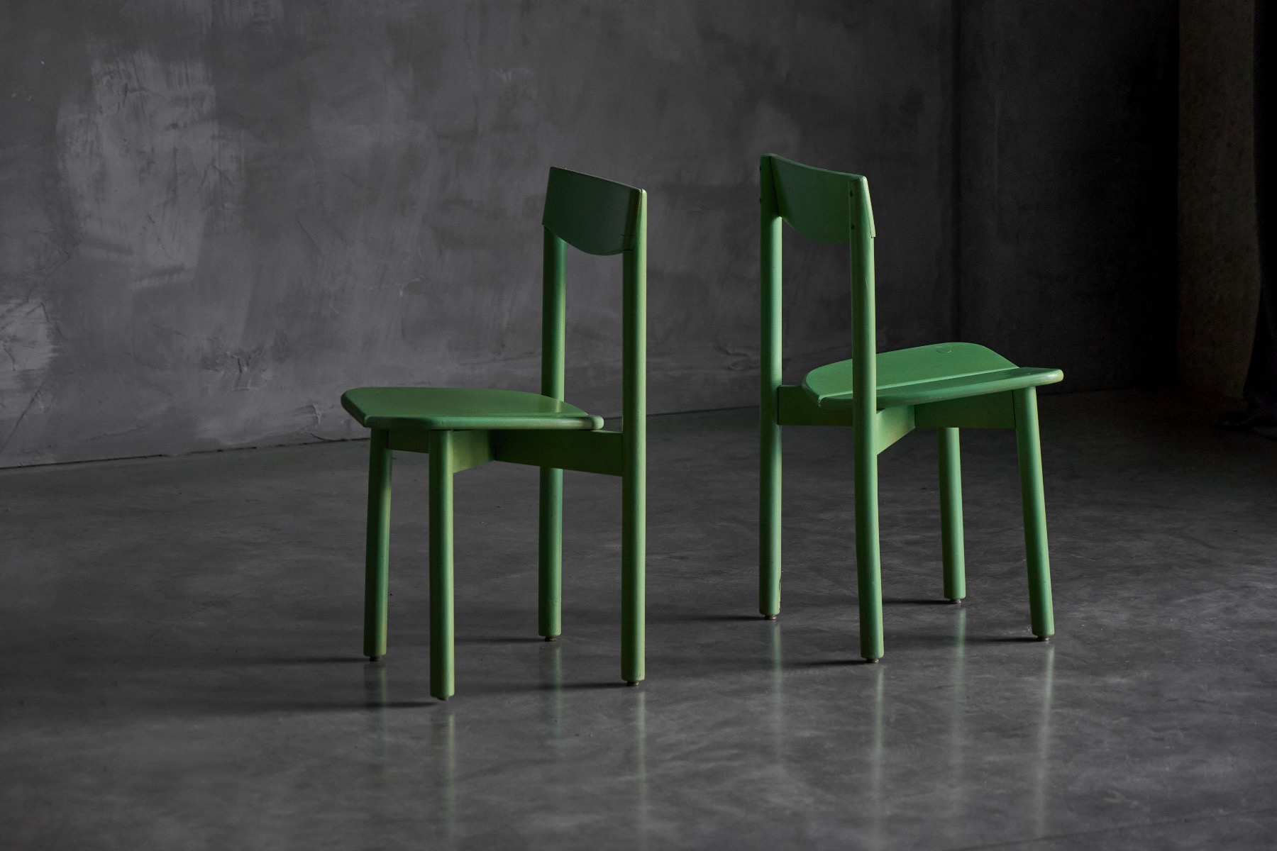 Green dining chair with flowing sculptural lines
