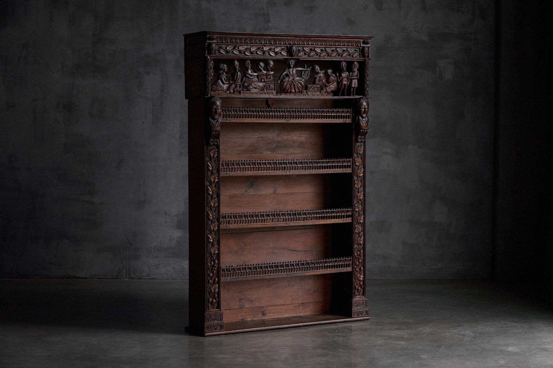 Antique expressive carved bookcase from France, 19th century with rich high relief wood carving