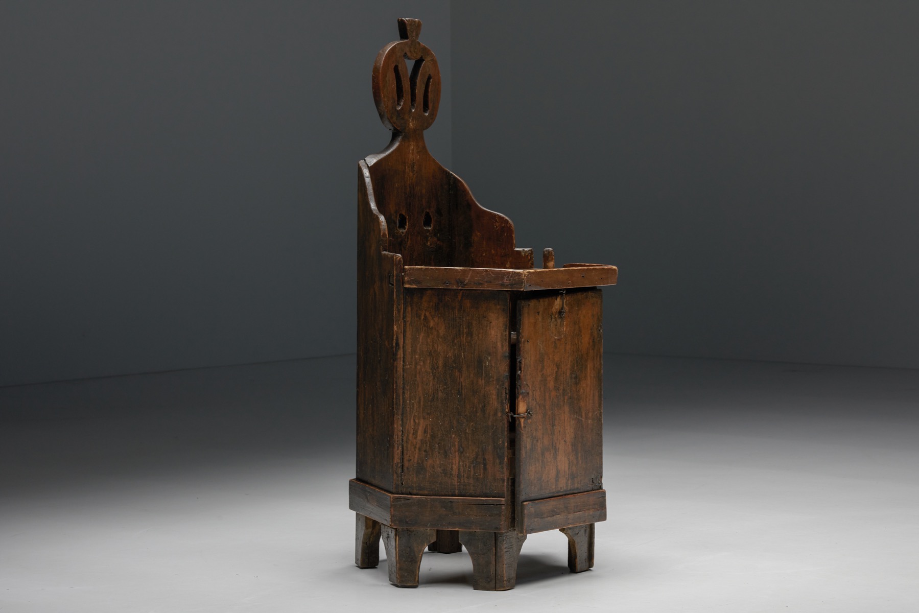 Rustic wooden child chair with inner compartment from the nineteenth century