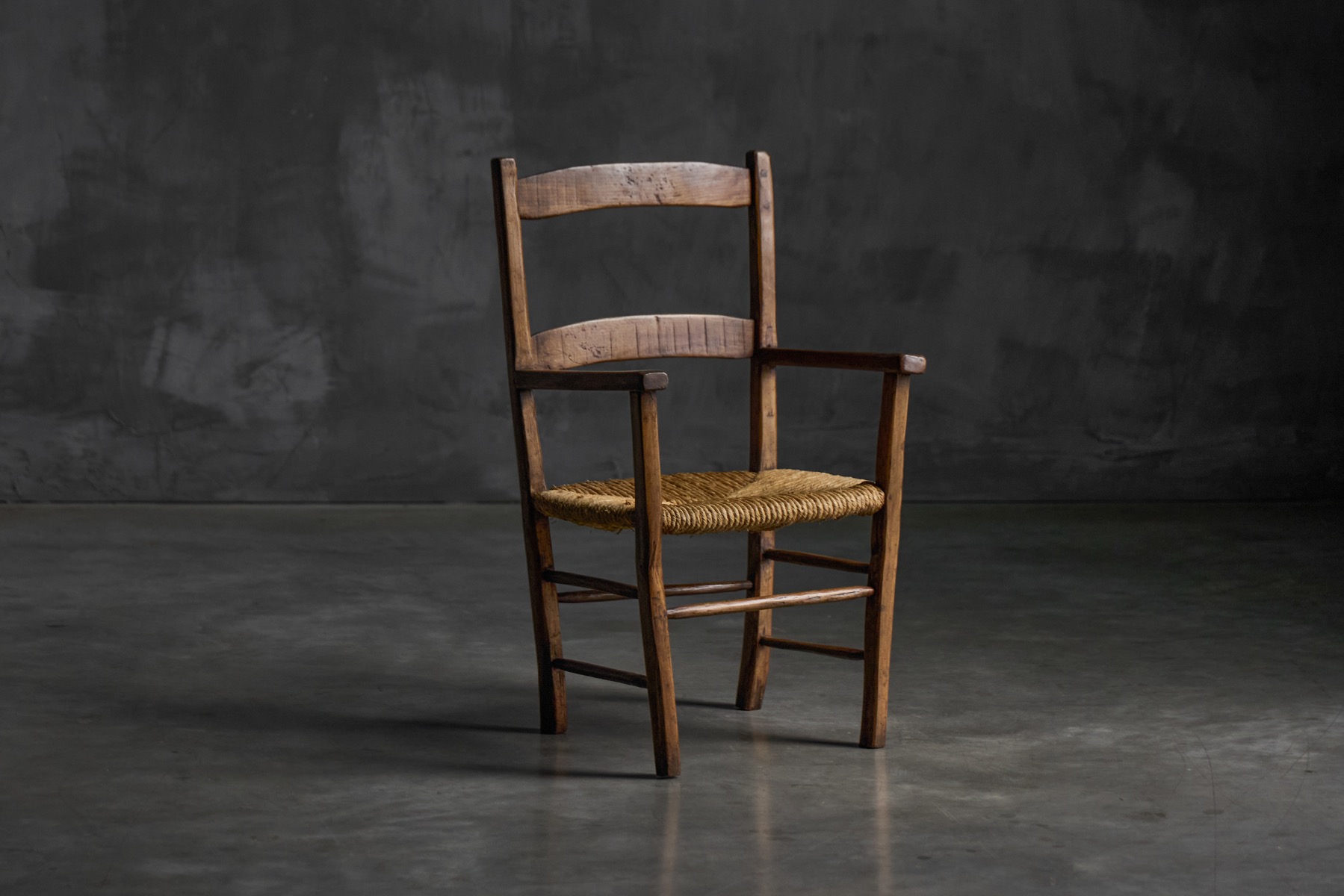Vernacular rural armchair in solid wood from the early 20th century
