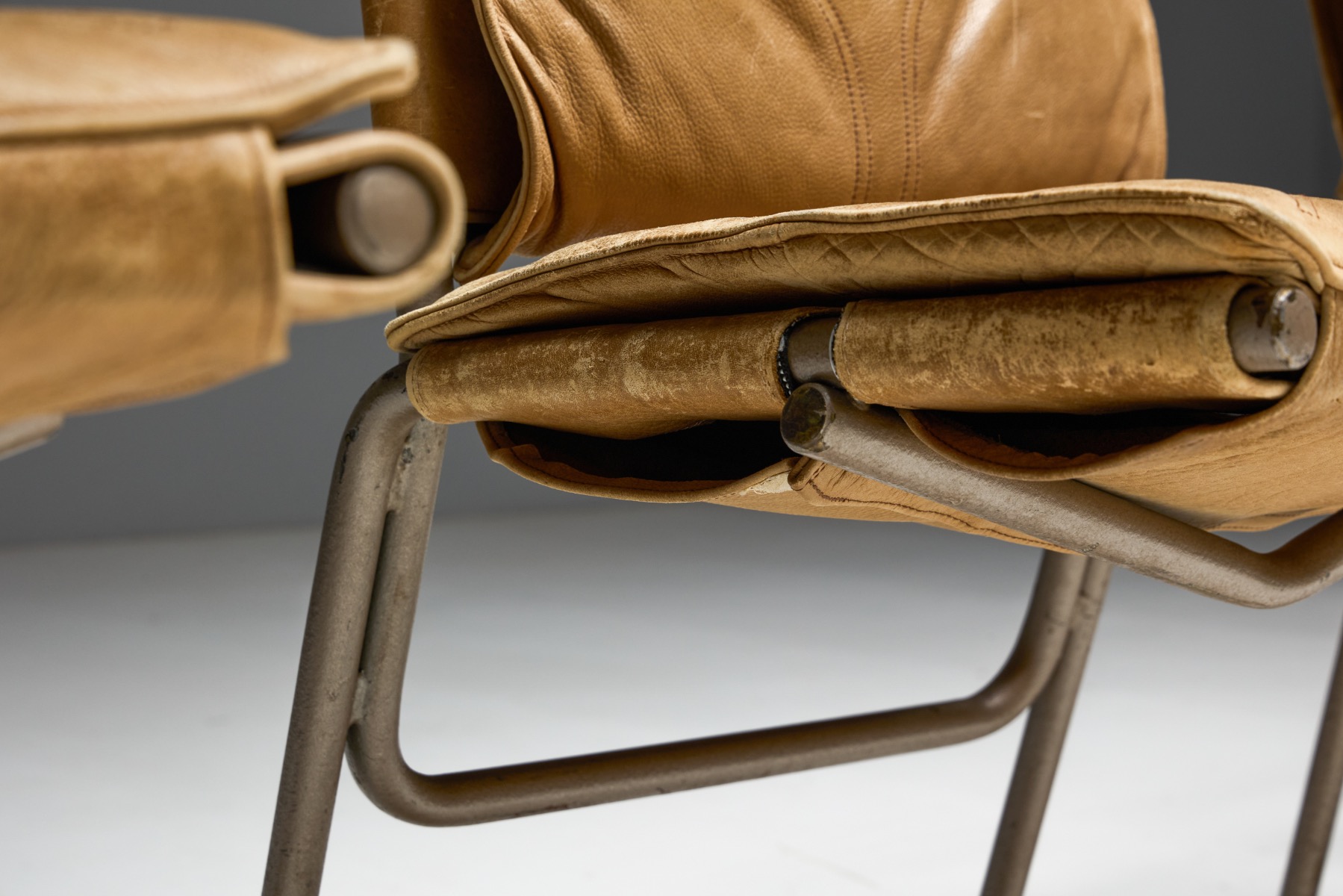 Sculptural dining chairs with steel frame and leather upholstery