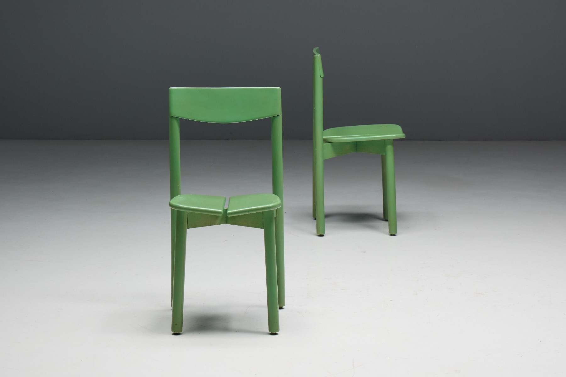 Understated modern green dining chair with organic shape