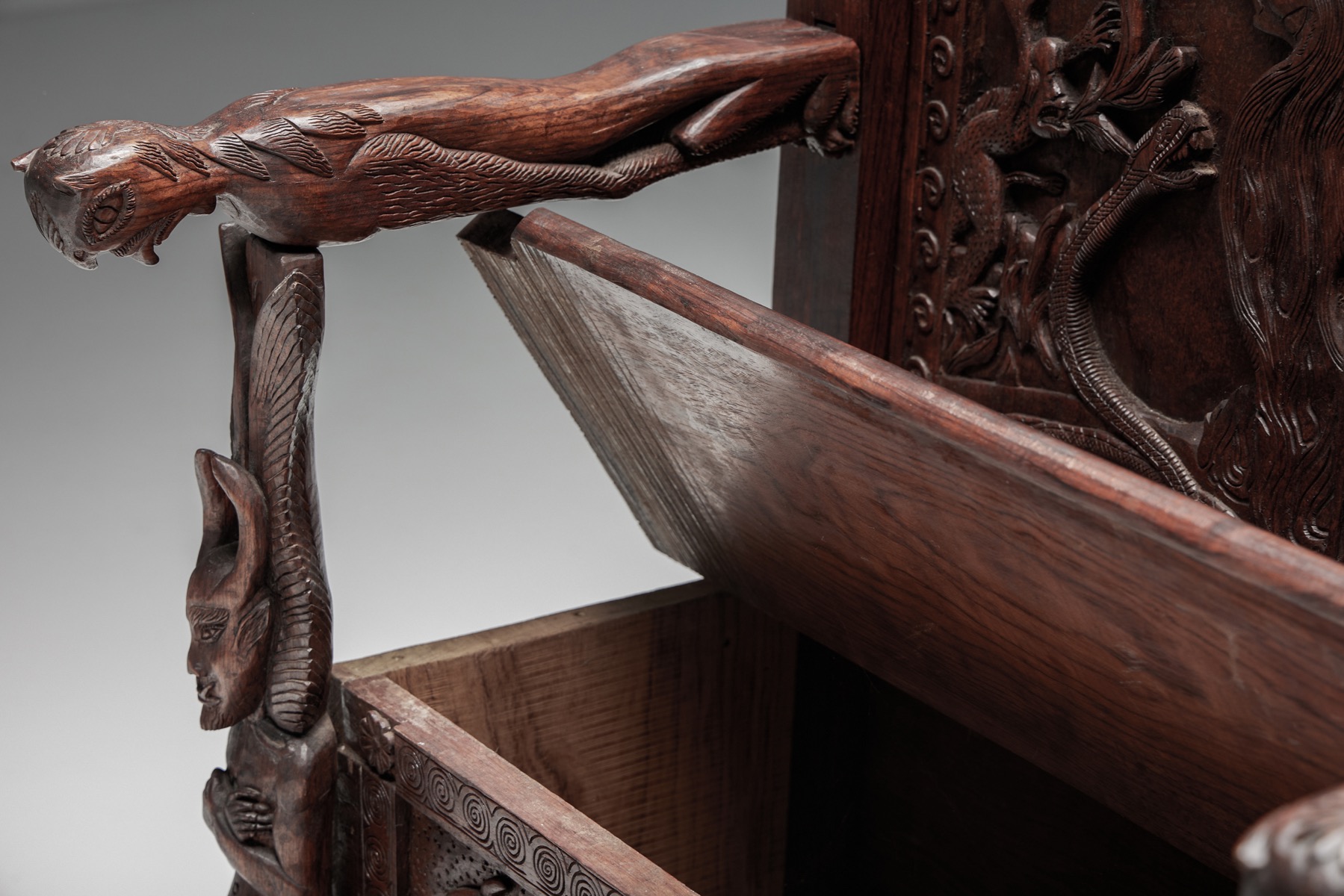 Detailed throne chair with relief carving in wood