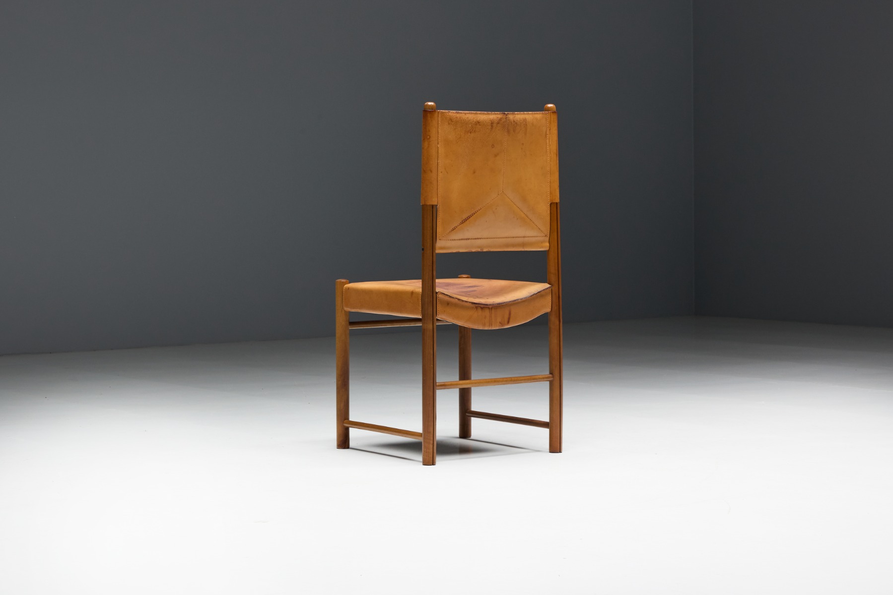 Elegant mid century dining chairs in brown leather