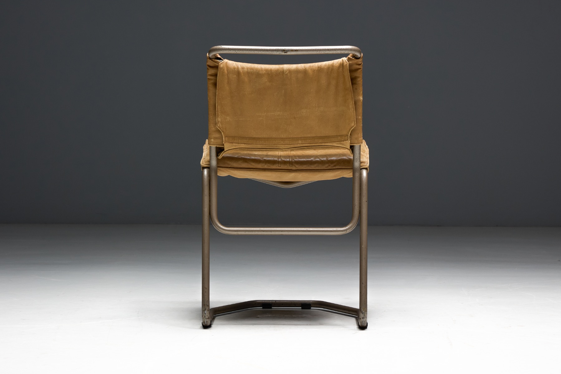 Iconic leather and steel dining chairs with modernist character
