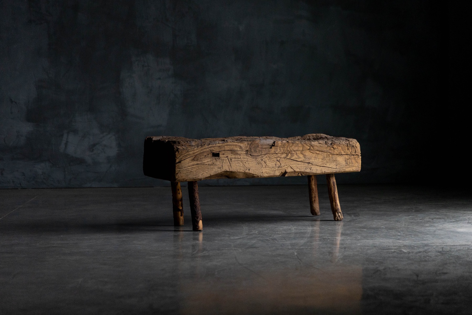 Primitive wooden bench from 1899 with rustic character