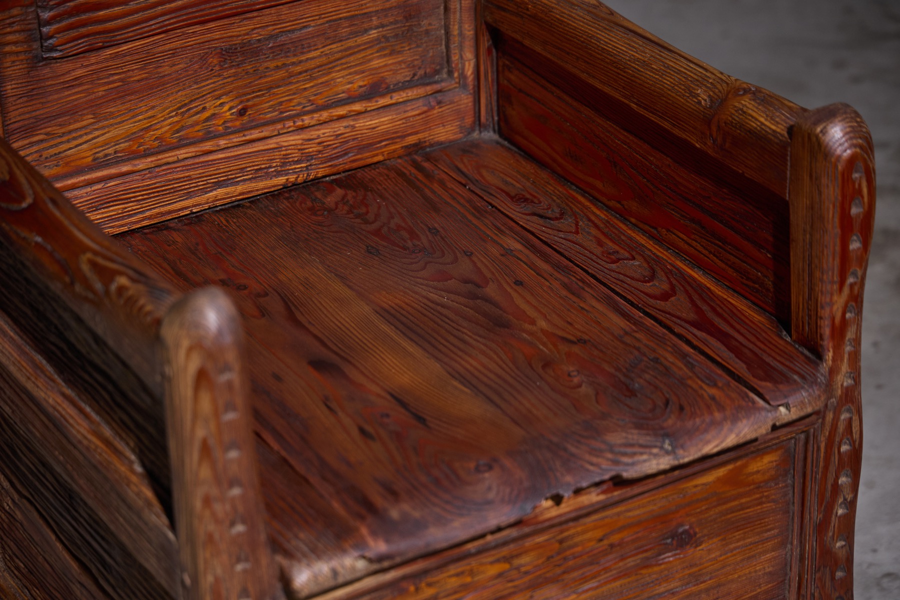 Antique wooden armchair featuring hidden storage space