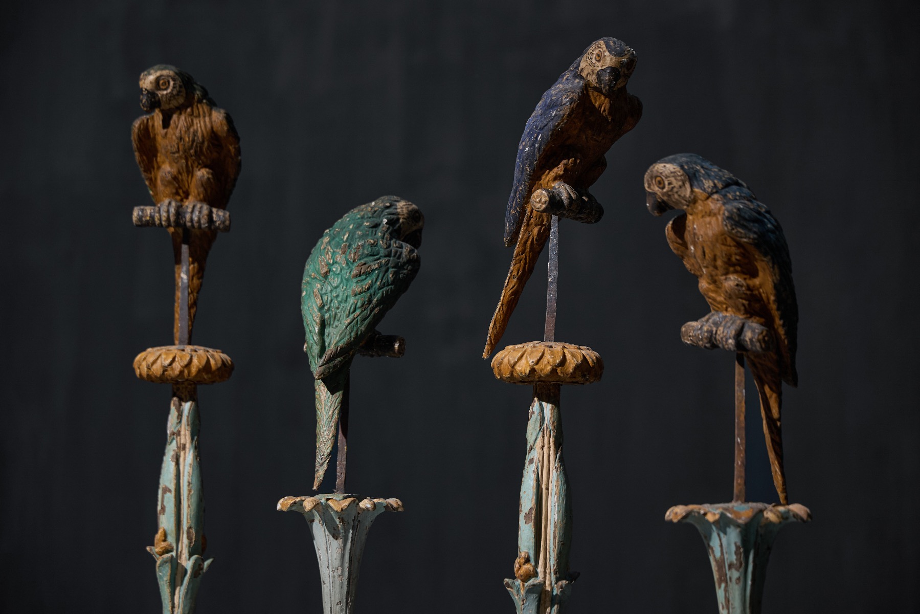 Antique parrot statues displayed on decorative pedestals
