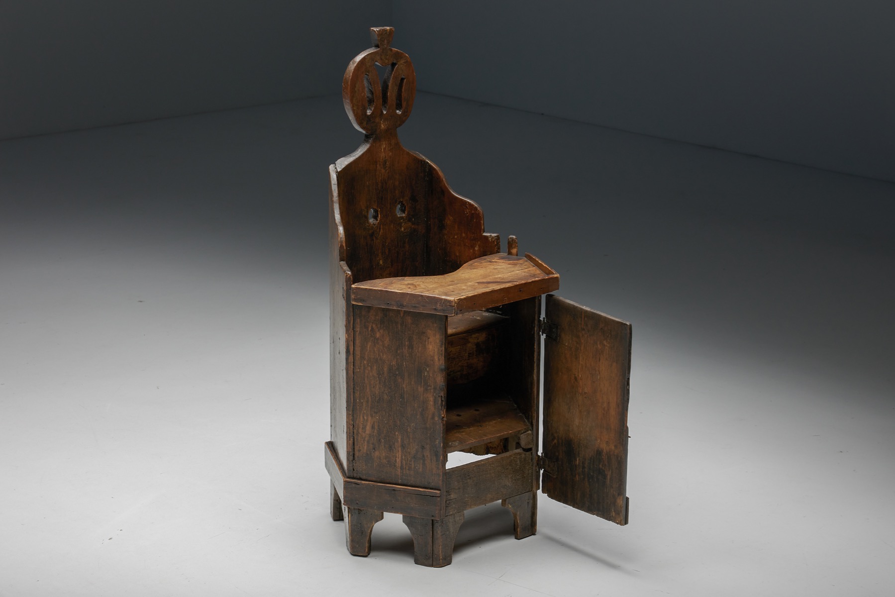 Antique wooden child chair with storage compartment