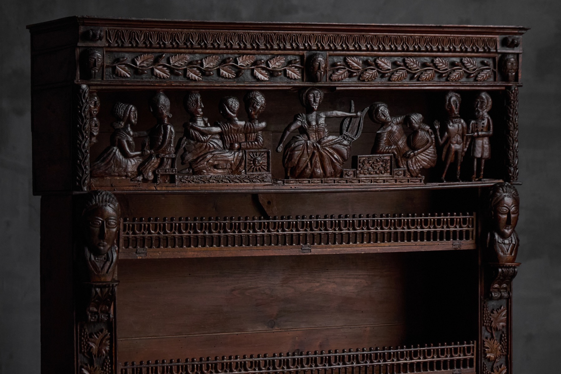 French 19th century carved bookcase in solid wood with decorative foliage and figural relief