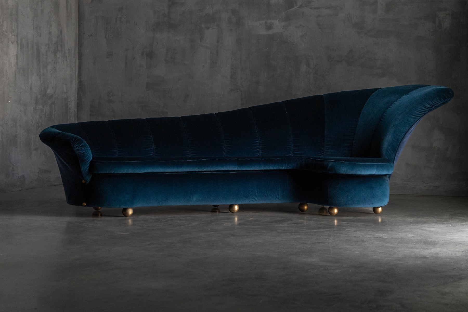 Hollywood Regency sofa with curved form and velvet upholstery