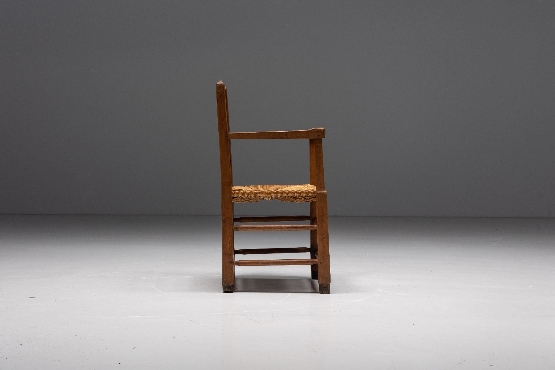 1940s solid wood armchair with woven straw seat