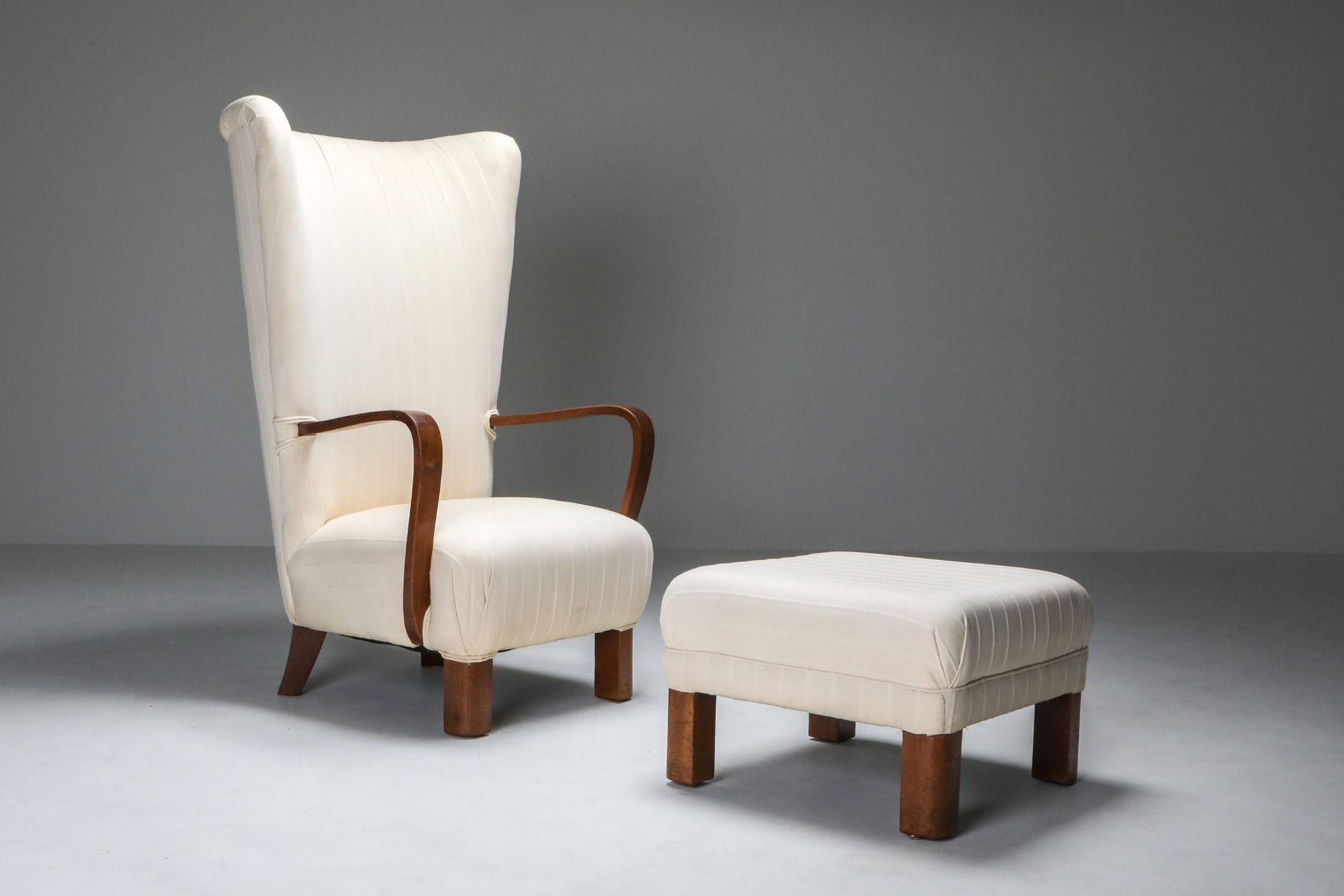 1950s wingback armchair with ottoman in white upholstery