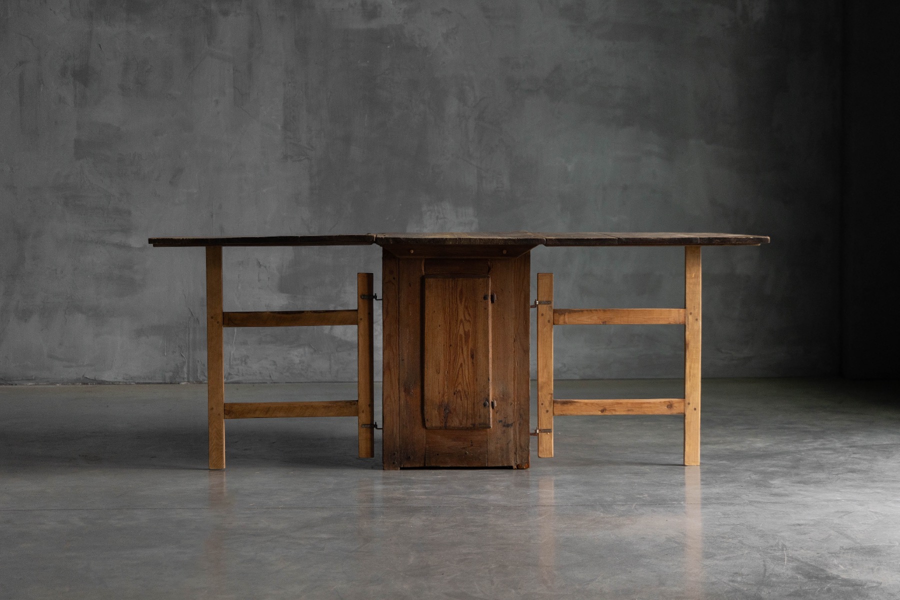 Antique vernacular worktable featuring folding drop leaves