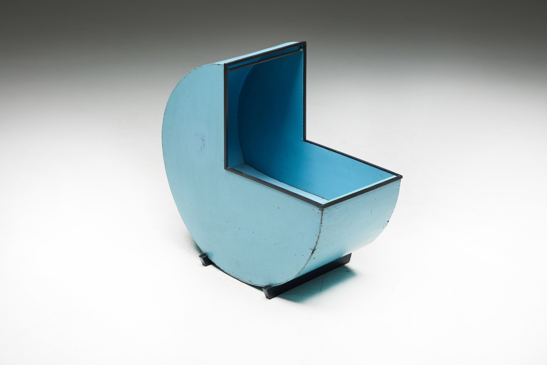 Handcrafted circular cradle in blue painted wood