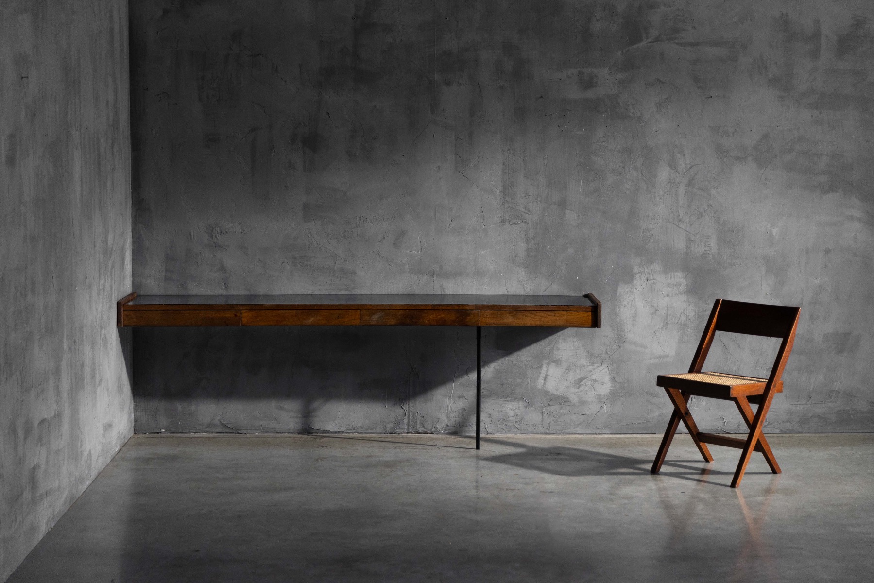 Modern wall mounted console featuring a warm wood base and black work surface
