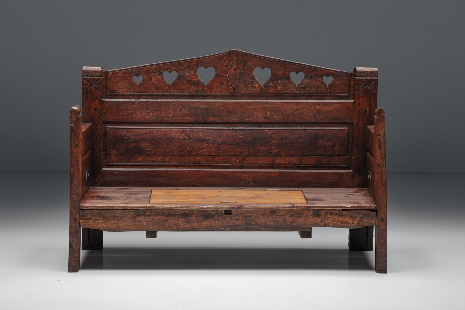 Primitive carved bench with hidden storage design