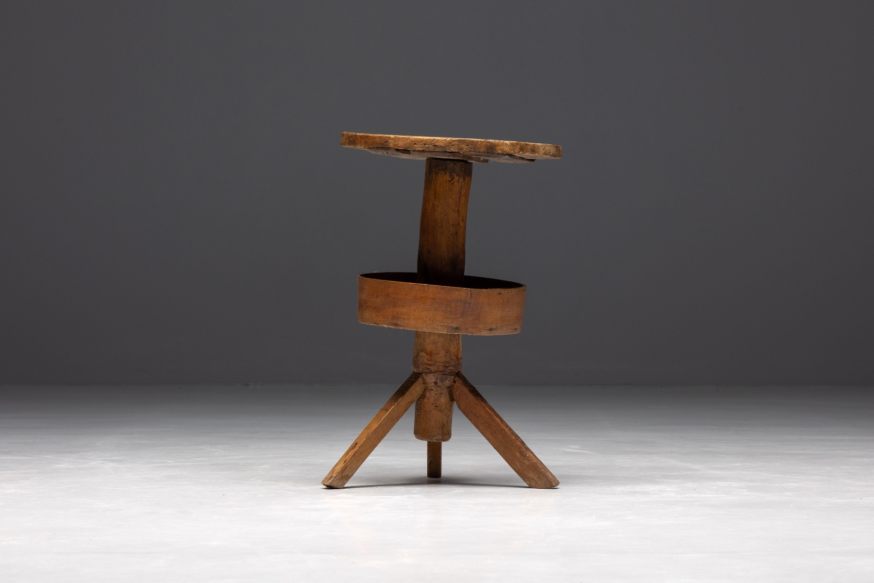 Primitive round side table with tripod base in wood