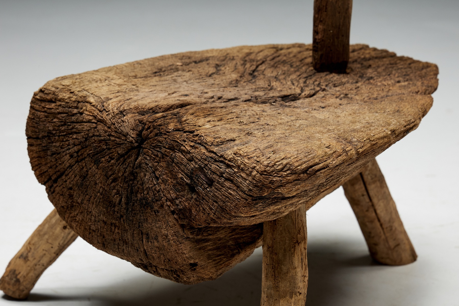 Primitive tripod hearth chair in monoxylite