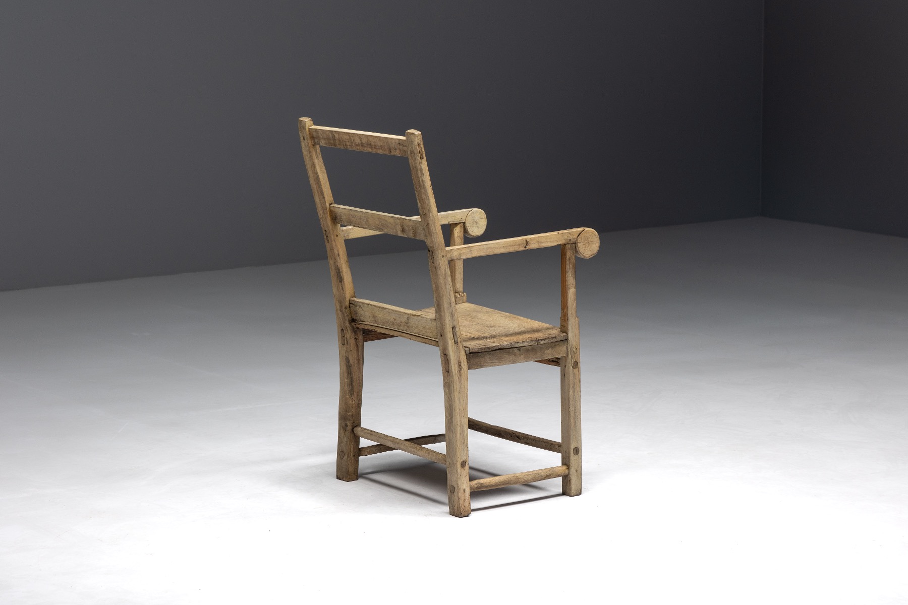 Primitive wooden armchair in art populaire style