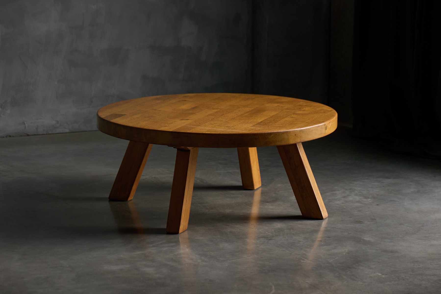 Round brutalist coffee table with sculptural wooden form