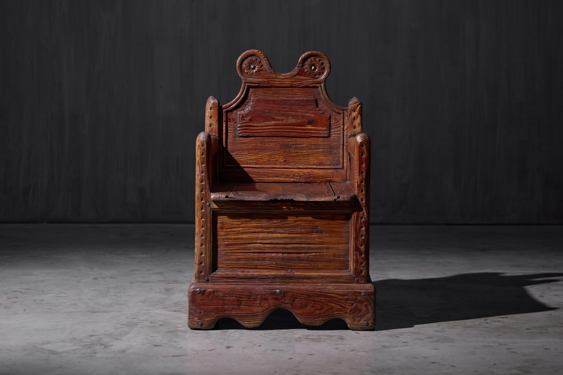 Rustic armchair with integrated compartment beneath the seat