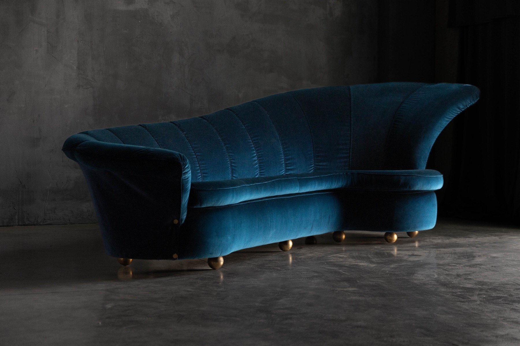 Vintage 1970s curved velvet sofa with glamorous presence