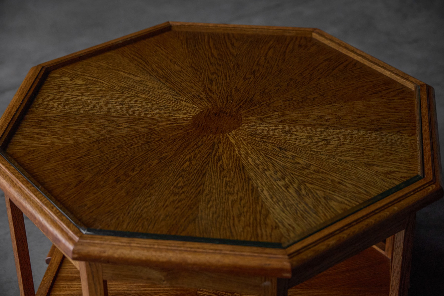 Art Deco coffee table with octagon top in wood emphasizing radial grain pattern 