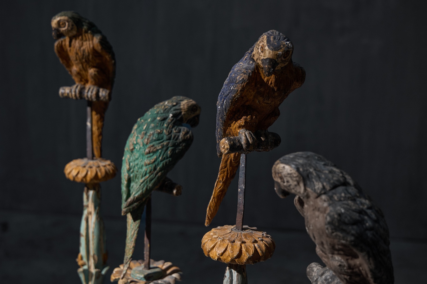 Carved parrot figures mounted on matching bases