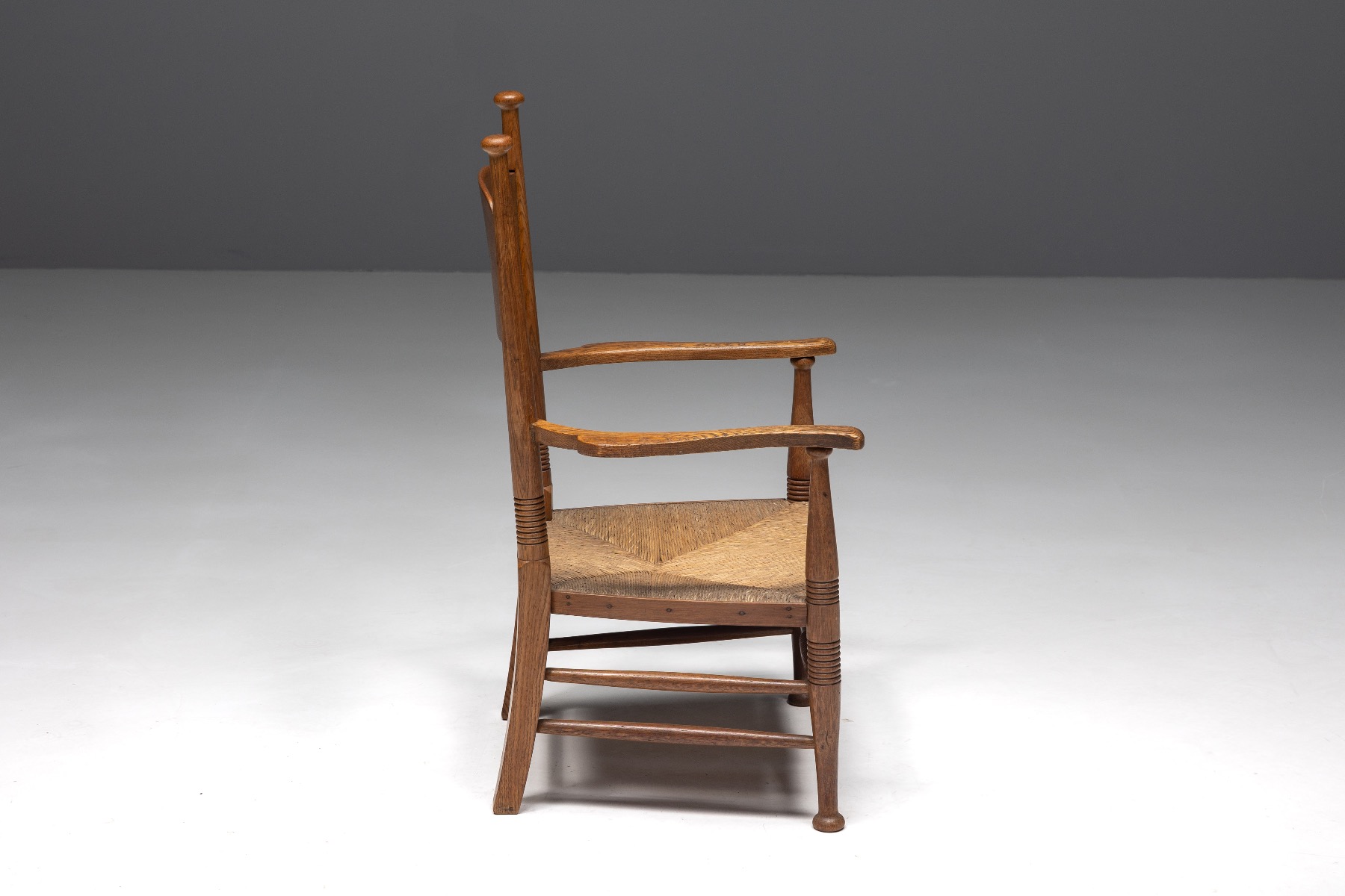Early twentieth century oak armchair with straw seating