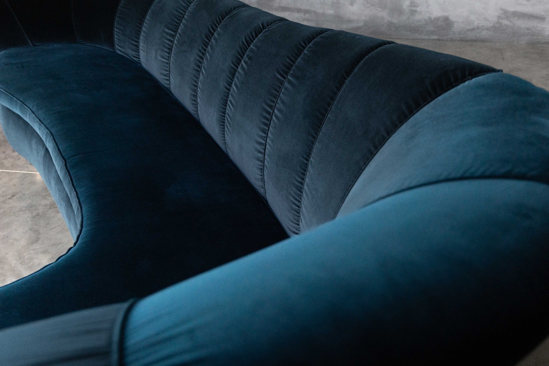 Glamorous Hollywood Regency curved sofa upholstered in velvet