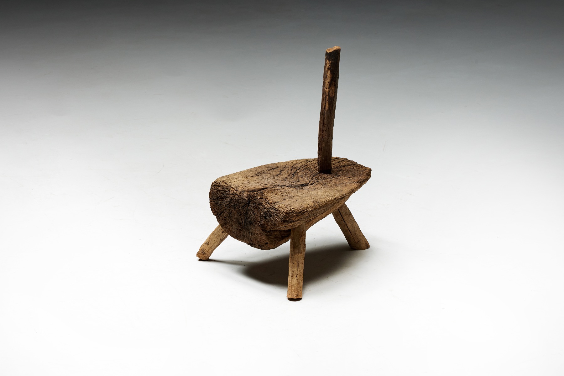 Nineteenth century monoxylite hearth chair with tripod base